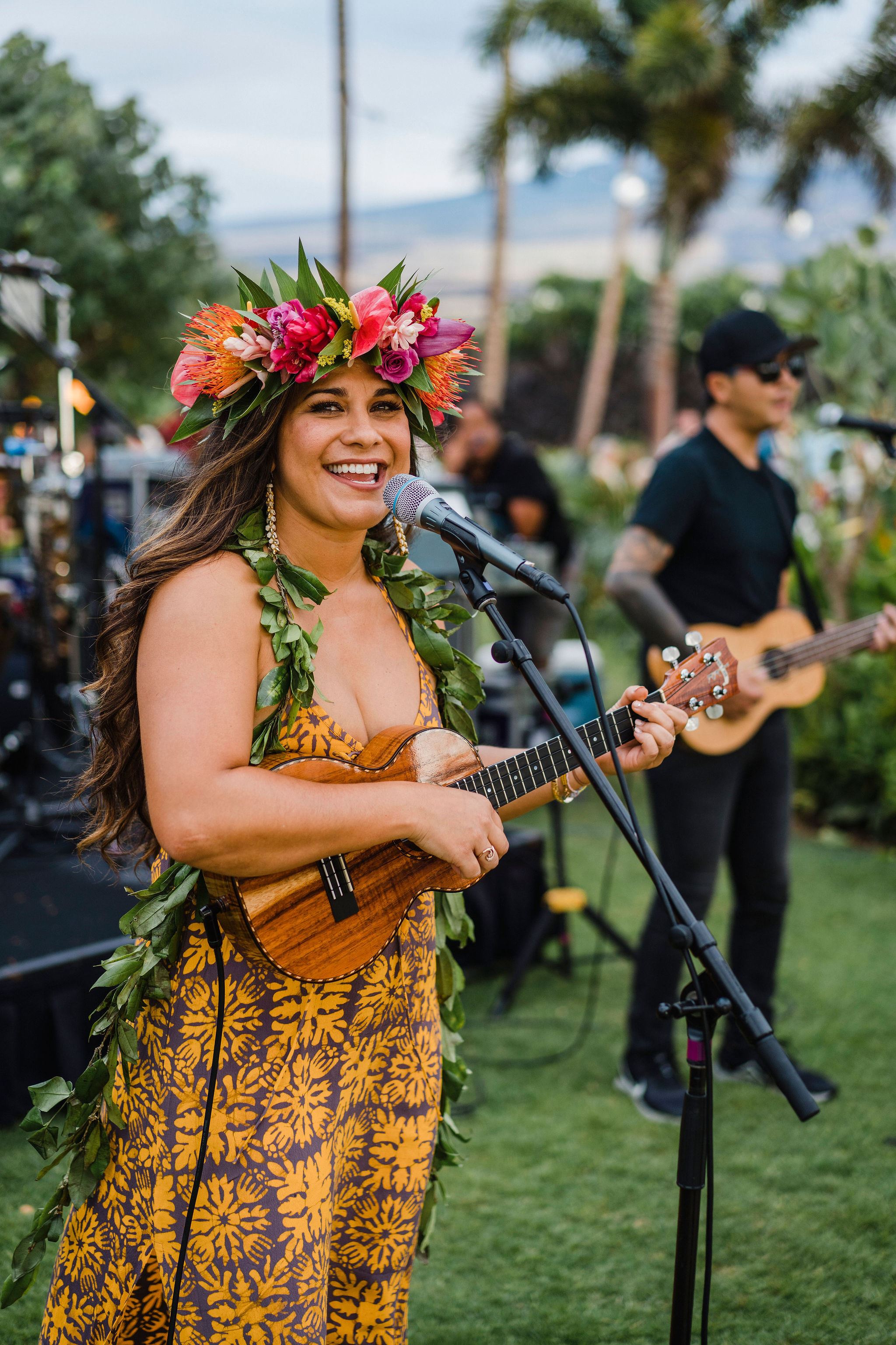 people in hawaiin attire greeting and looking at the camera