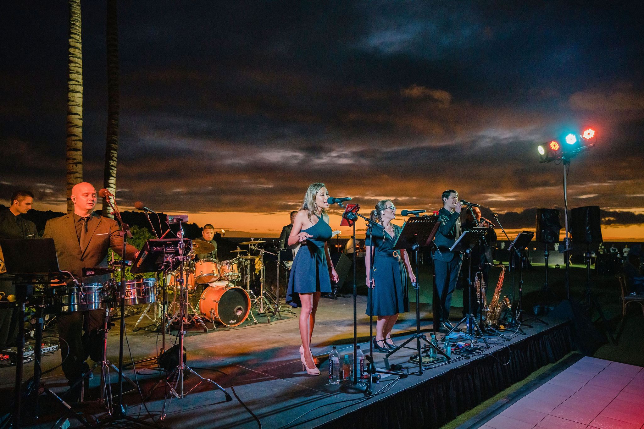 people in hawaiin attire greeting and looking at the camera